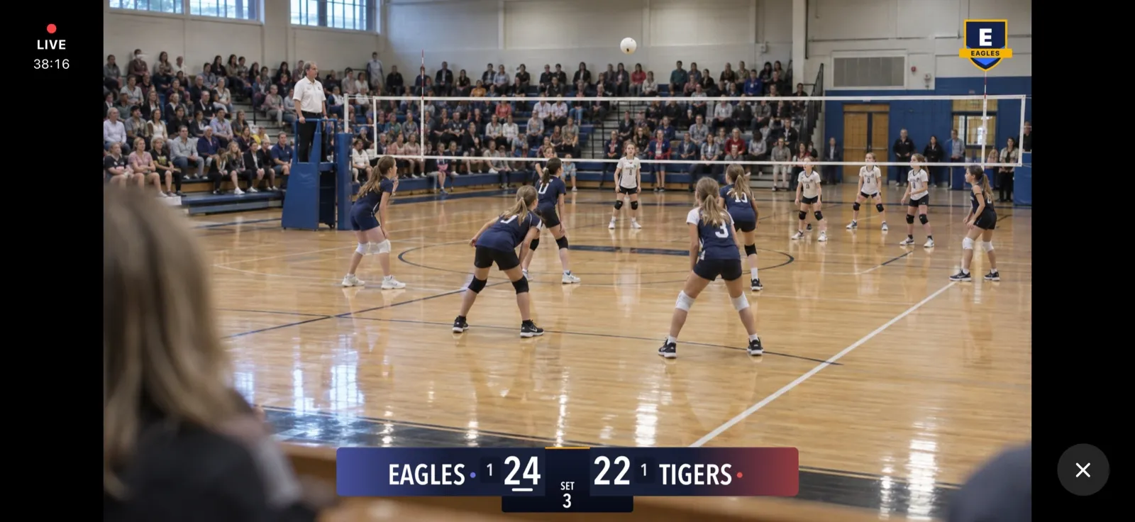 Stream View: the exact frame viewers see, with the crest top right and the scoreboard along the bottom